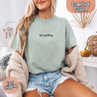 He’s Grilling – Funny Summer BBQ Comfort Color Shirt for Women - A Roese Boutique