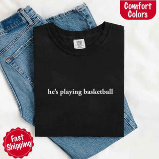 He’s Playing Basketball – Funny Sports Girlfriend Comfort Color Shirt for Women - A Roese Boutique