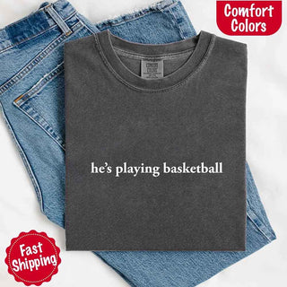 He’s Playing Basketball – Funny Sports Girlfriend Comfort Color Shirt for Women - A Roese Boutique