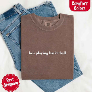 He’s Playing Basketball – Funny Sports Girlfriend Comfort Color Shirt for Women - A Roese Boutique
