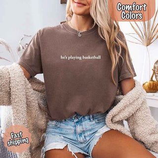 He’s Playing Basketball – Funny Sports Girlfriend Comfort Color Shirt for Women - A Roese Boutique