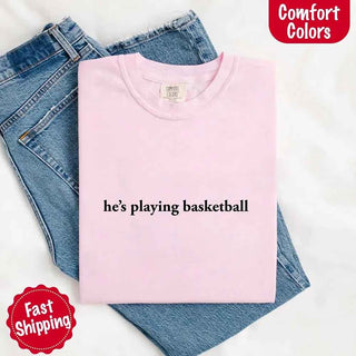 He’s Playing Basketball – Funny Sports Girlfriend Comfort Color Shirt for Women - A Roese Boutique